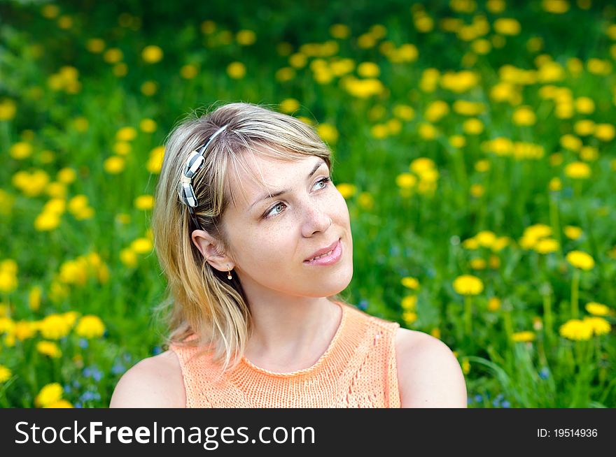 Portrait of a young woman on the grass background. Portrait of a young woman on the grass background