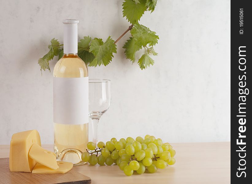 Still-life with bunch of grapes and white wine