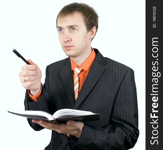 The isolated portrait of the young businessman. Serious, with the daily log and the handle. The isolated portrait of the young businessman. Serious, with the daily log and the handle.