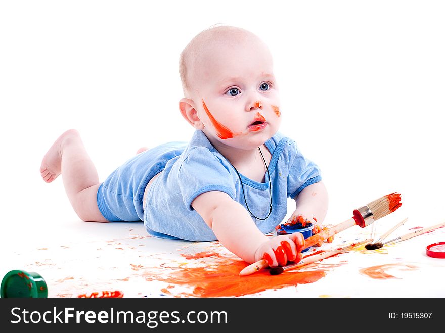 Portrait of a cheerful grimy kid. playing with paint. on a white studio background. Portrait of a cheerful grimy kid. playing with paint. on a white studio background.