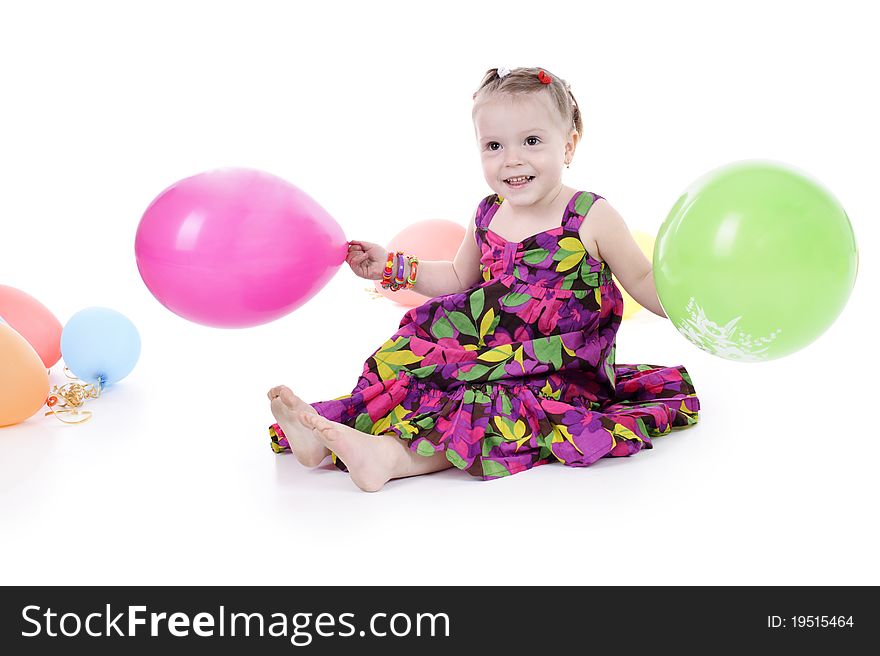 Little girl in a bright dress isolated on a white background.