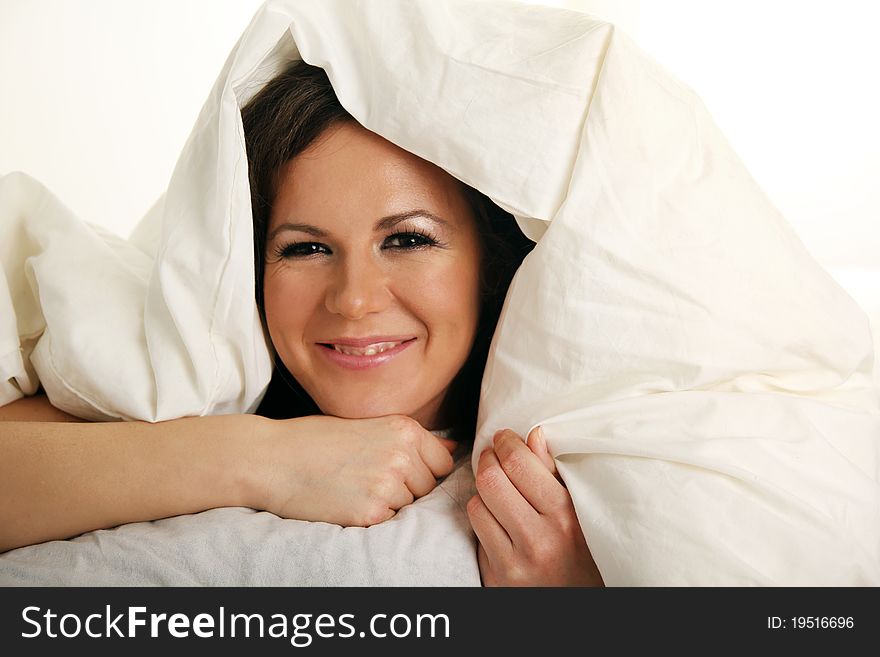 Smiling Girl Under White Blanket