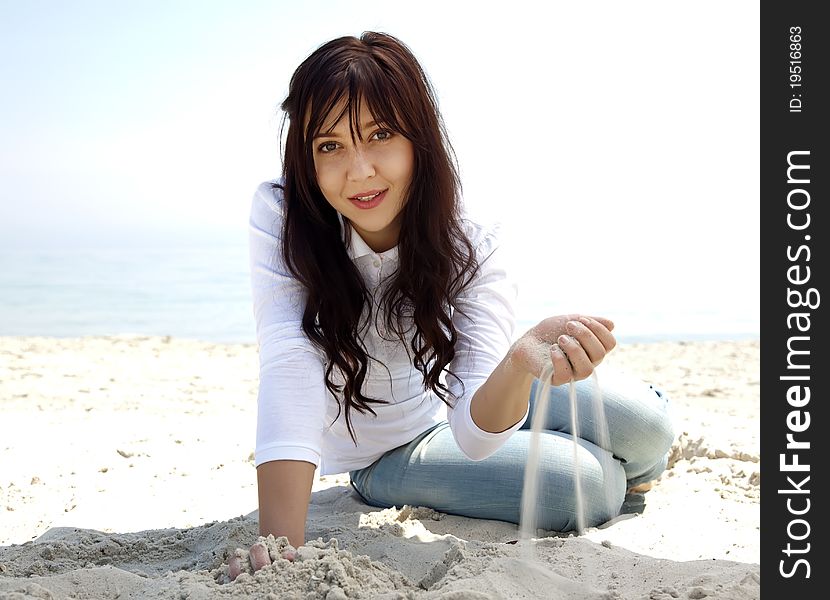 Brunette Girl At The Beach In Spring Time.