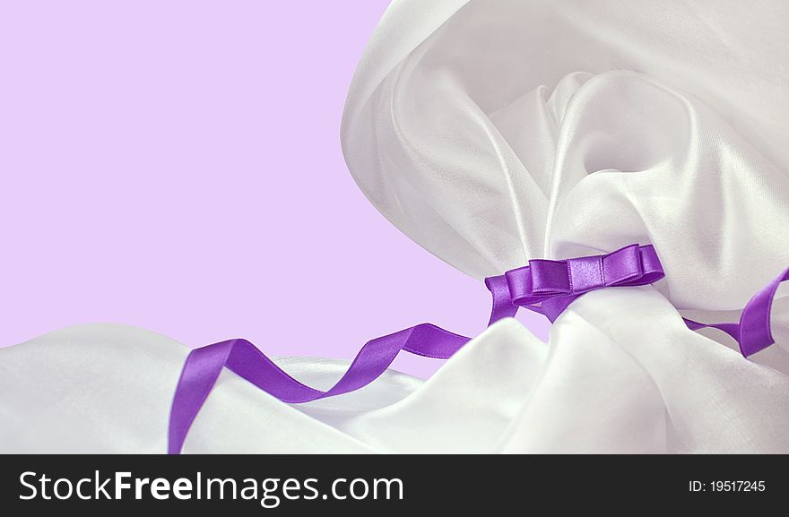 Violet holiday ribbon bow on background. Violet holiday ribbon bow on background