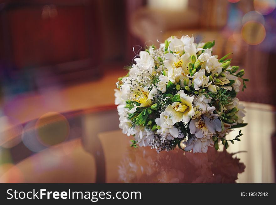 White wedding bouquet on the glass table