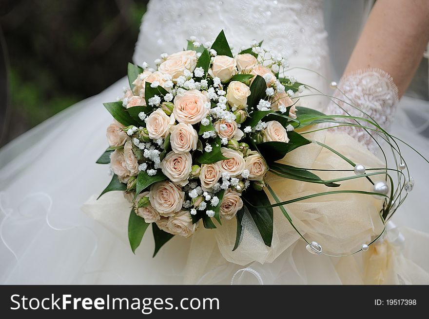 Closeup of bride hands holding beautiful wedding bouquet