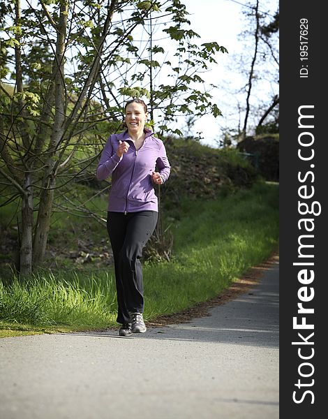 Women in sportswear jogging in a park. Women in sportswear jogging in a park