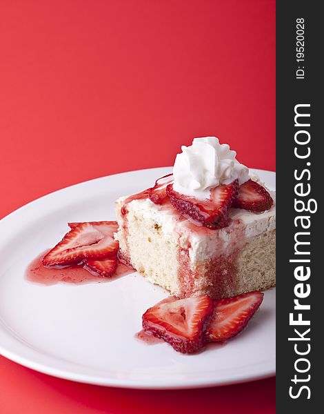 Strawberry shortcake on a red background sliced berries and whipped cream