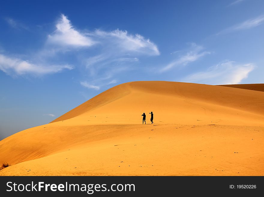 Photo of sand dunes with travellers. Photo of sand dunes with travellers