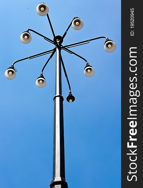 A lamppost with white lamp