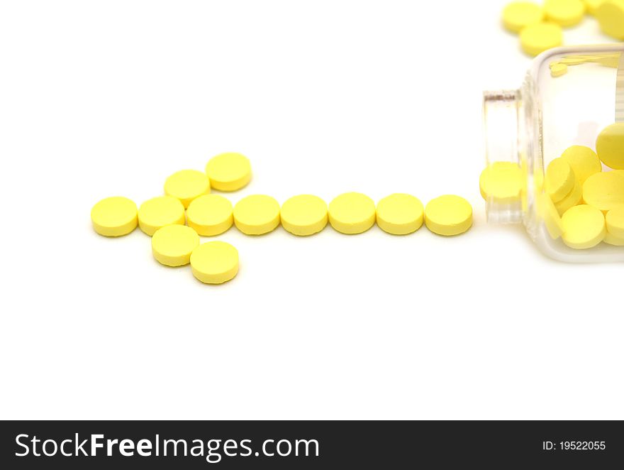 Pills in vial isolated on white background