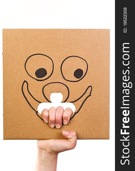 Sheet of corrugated cardboard with sketch of smiling face in hand isolated on white