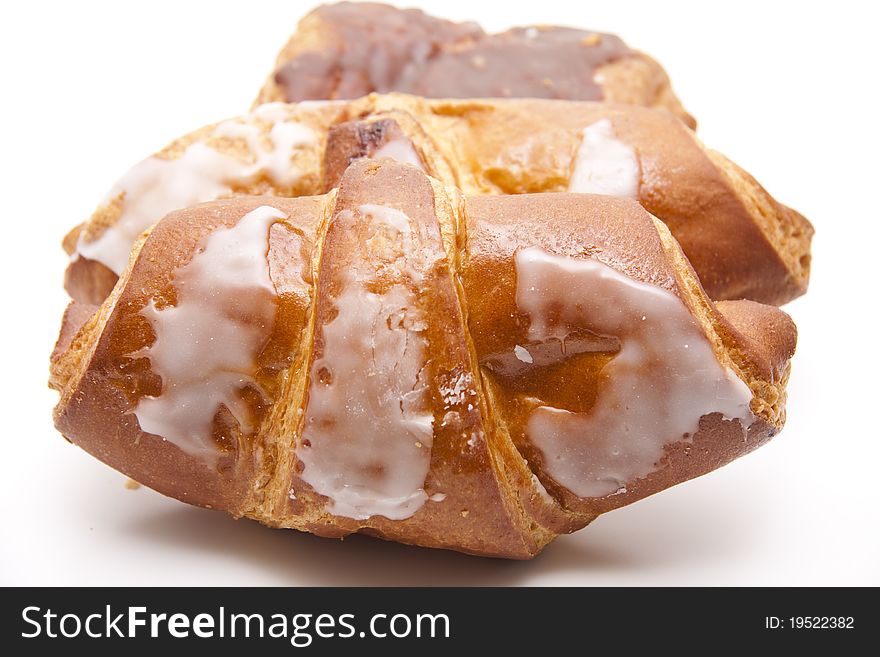 Croissant with sugar glaze onto white background