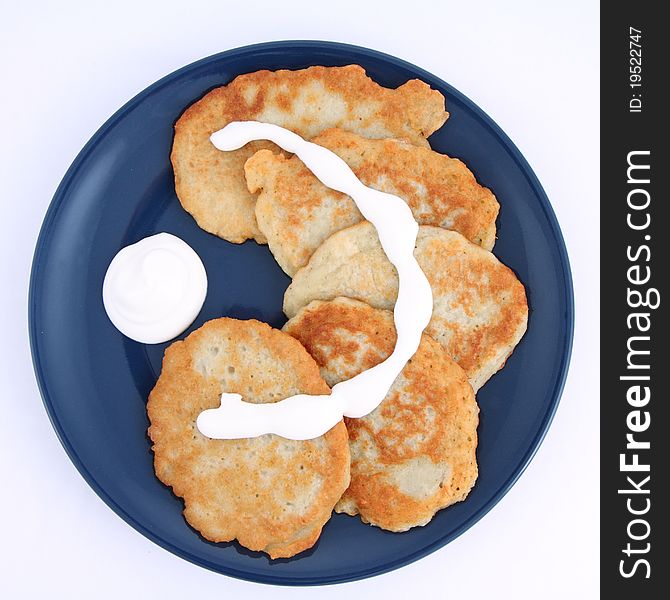 Potato pancakes with cream isolated on white background