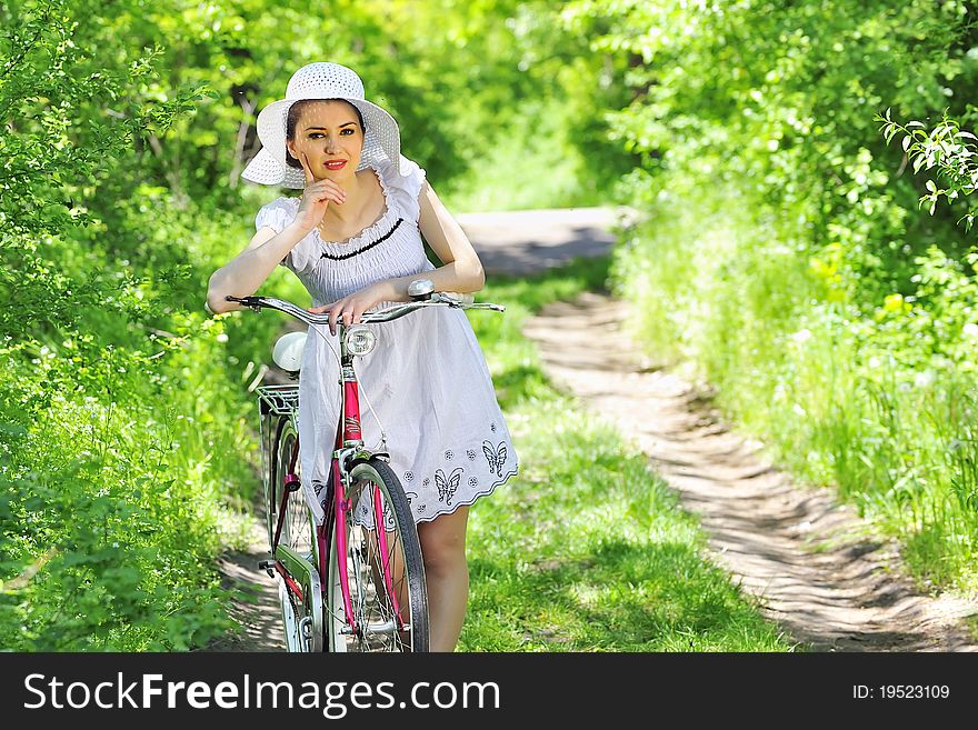 Young woman with a vintage bicycle in spring  time