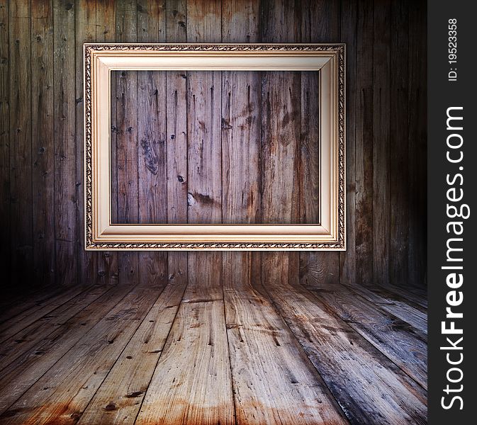 Rusty vintage wooden interior with golden frame hanging on the wall