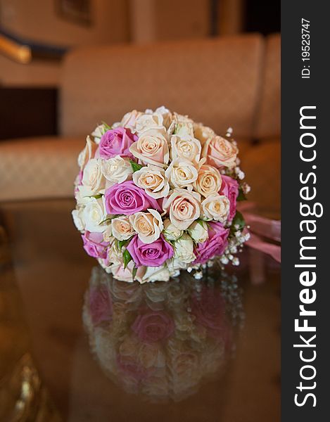 Wedding bouquet over the glass table. Wedding bouquet over the glass table