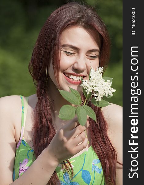 Laughing young woman with flower