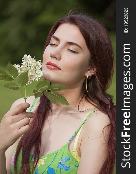 Happy young woman in field with flower in her hands. Happy young woman in field with flower in her hands