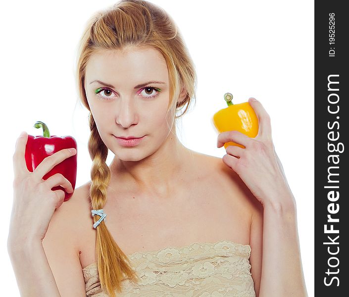 Woman with yellow and red peppers isolated on white