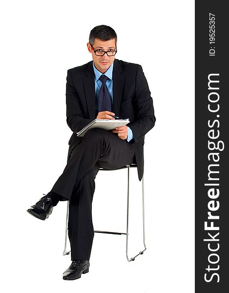 Sitting businessman with eyeglasses writing