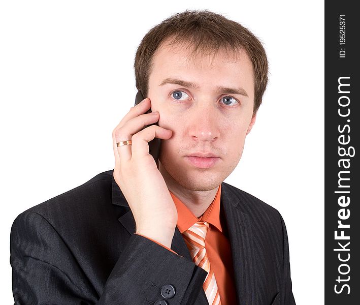 The businessman speaks by a mobile phone. The businessman speaks by a mobile phone