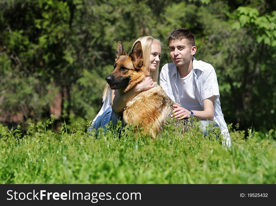 Young couple with dog outdoors