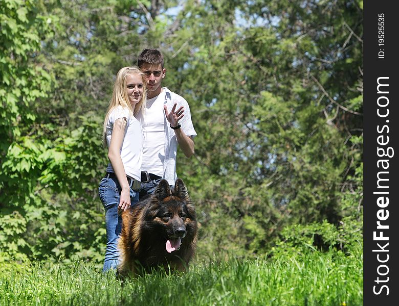 Young couple with dog outdoors