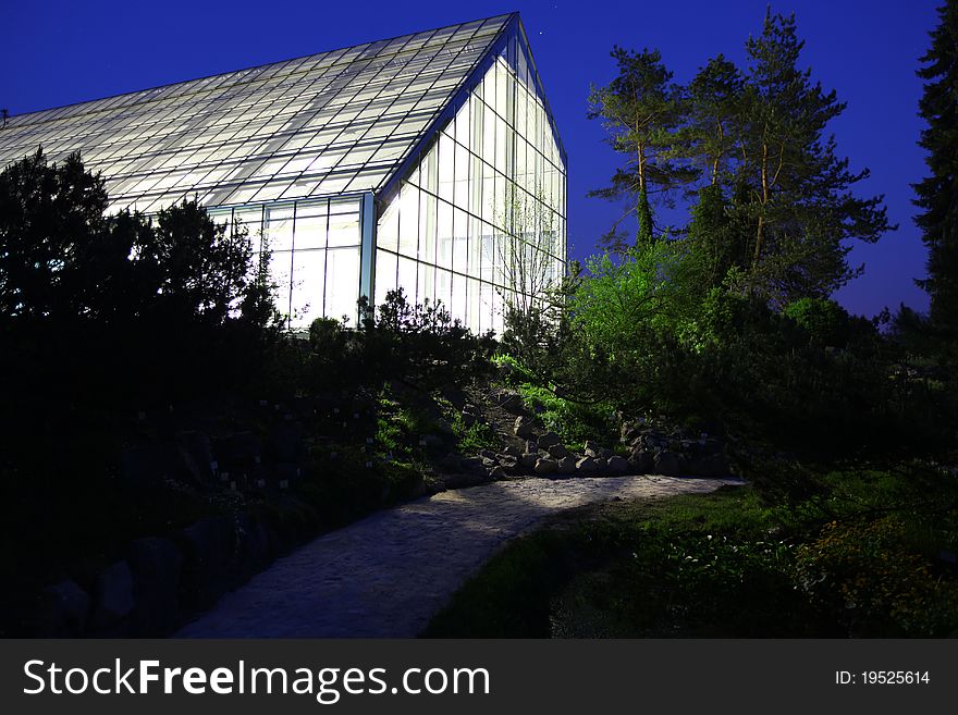 Greenhouse illuminated against night sky