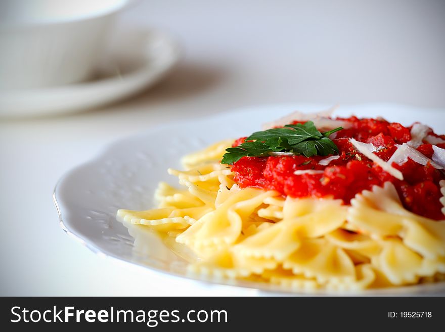 Pasta farfalle with tomato sauce and parsley