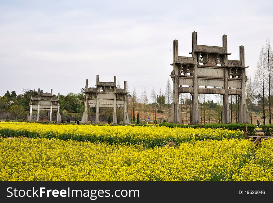 Landmark of Chinese ancient Memorial Archway in the blooming rapeseed fields. Landmark of Chinese ancient Memorial Archway in the blooming rapeseed fields