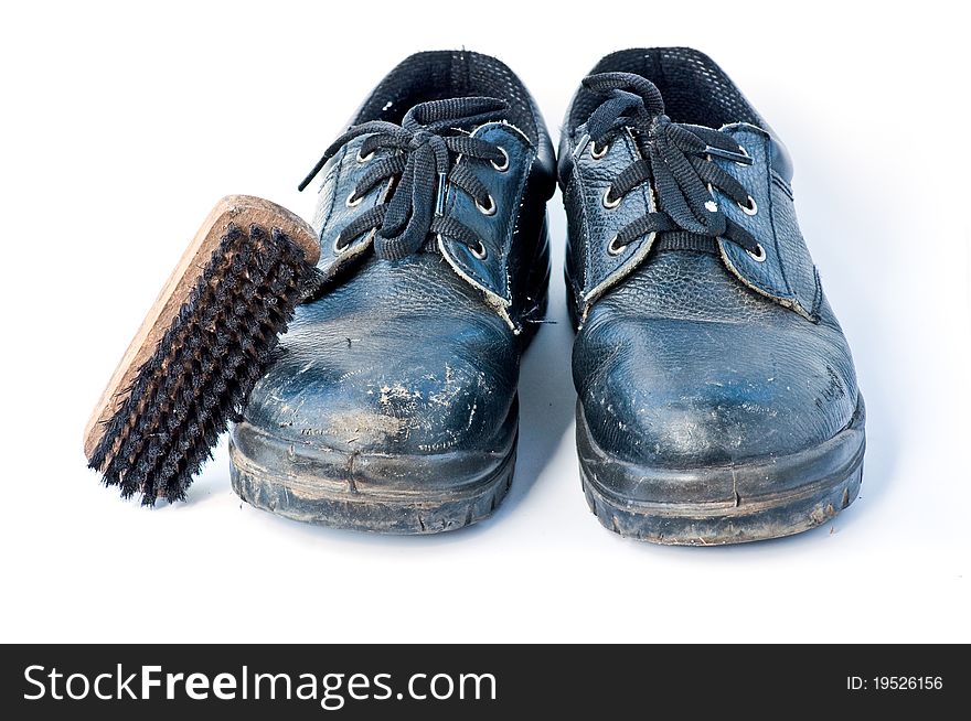 Old Safety shoes and brush on the white background,phitsanulok