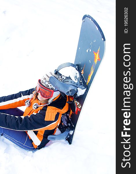 Girl with blue snowboard in snow. Girl with blue snowboard in snow