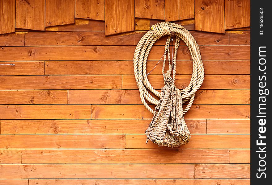 Orange old texture of wooden boards with ship rope.