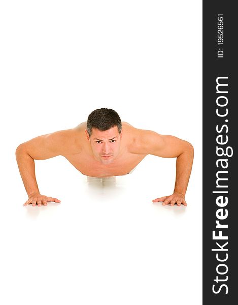 Man in white does push-ups in white background