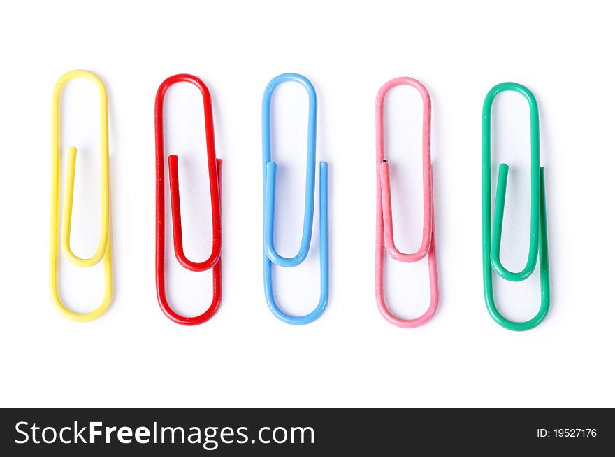 Closeup of multi-colored paper clips on white