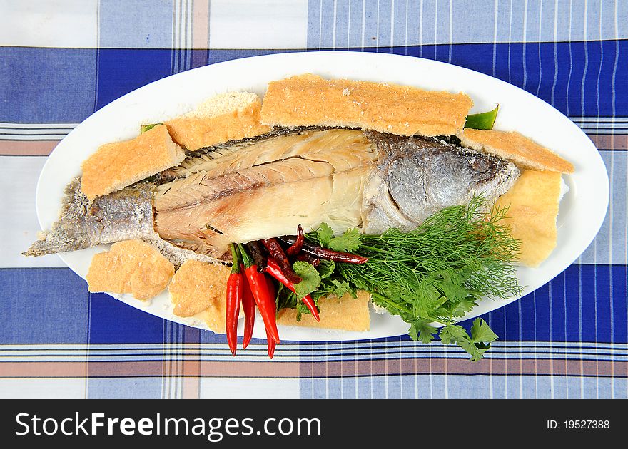 Whole fried bass on plate