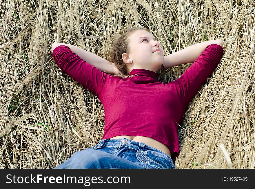 Girl Lays On A Dry Grass