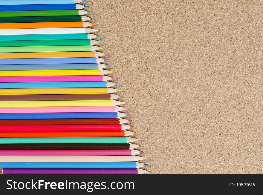 The colour pencils on сorkboard. School concept