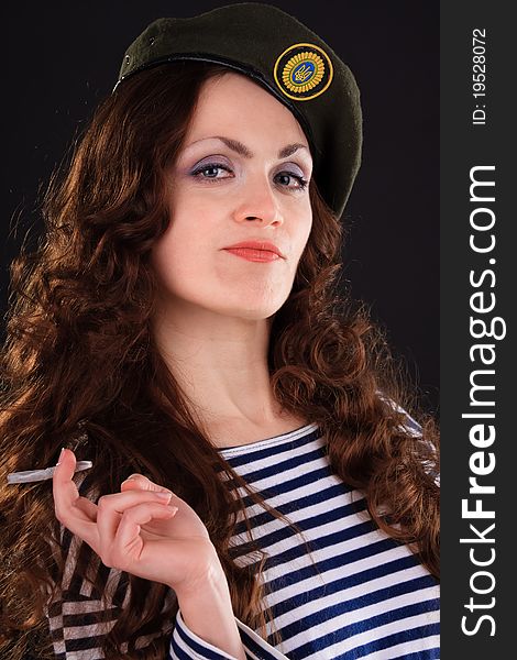 Emotional portrait of a girl in a vest and a military beret. Emotional portrait of a girl in a vest and a military beret