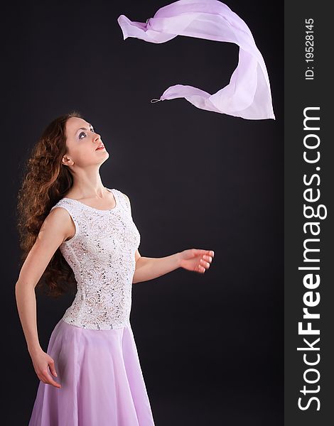 Portrait of beautiful woman in a lilac dress with scarf