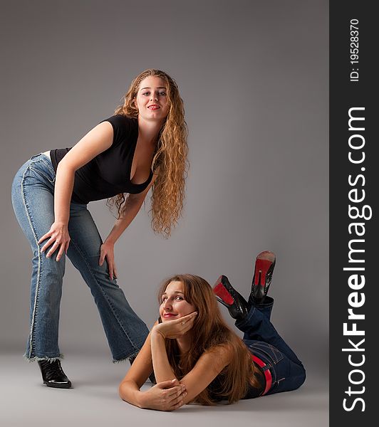 Two beauty woman look at you - contemporary jeans style. Two beauty woman look at you - contemporary jeans style
