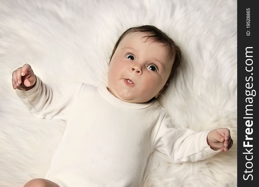 Sweet little baby on white fur. Sweet little baby on white fur