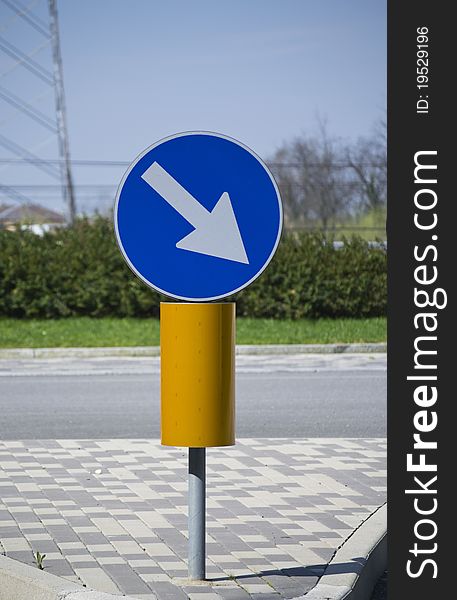 Road Sign In A Sunny Day.