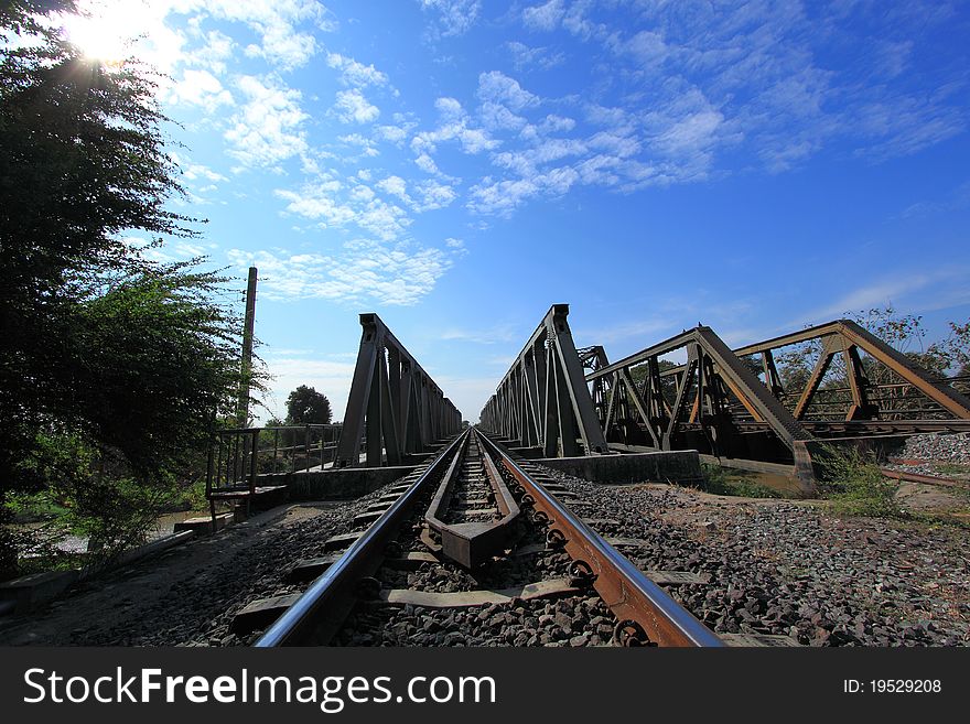 Metal railway bridge with blue sky