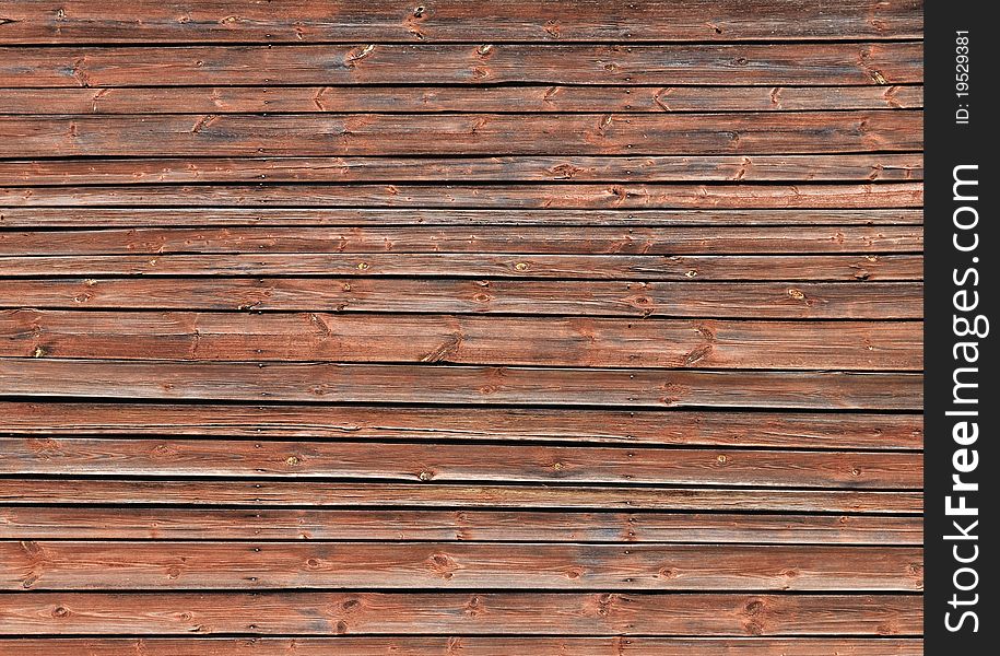 Fragment of old brown wooden wall background. Fragment of old brown wooden wall background