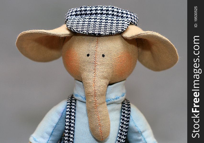 Handmade elephant in a plaid cap