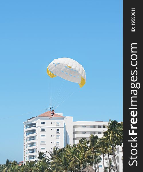 White and yellow parachute in a tropical resort. White and yellow parachute in a tropical resort