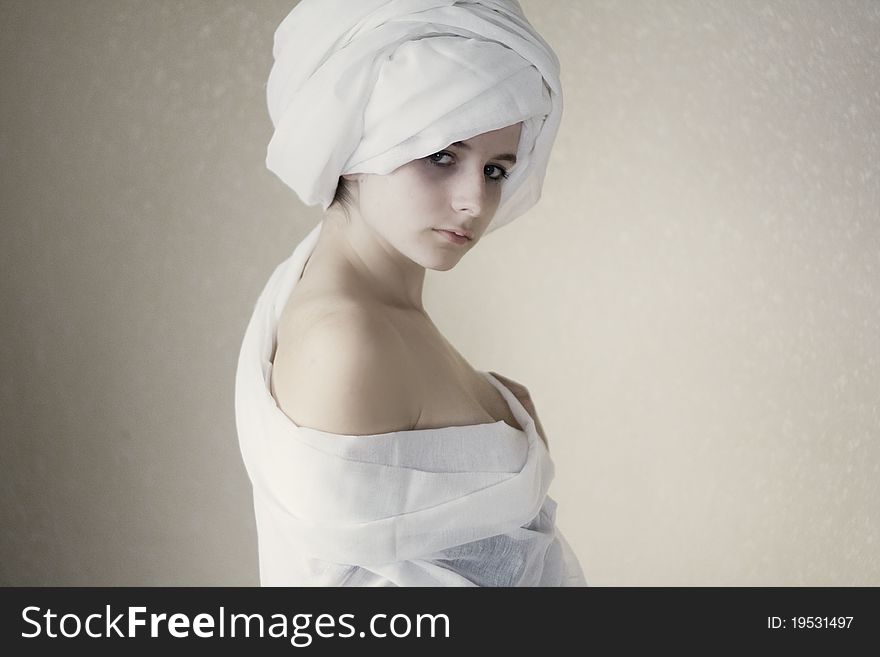 A portrait of a young woman wearing a turban. A portrait of a young woman wearing a turban