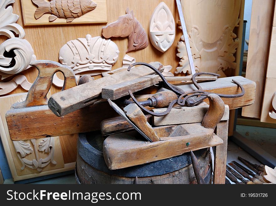 Woodworking tools with the wooden ornaments on workbench